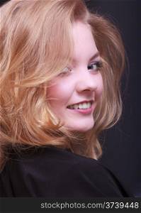 Beautiful smiling girl with blond wavy hair by hairdresser. Young woman in hairdressing beauty salon. Hairstyle.