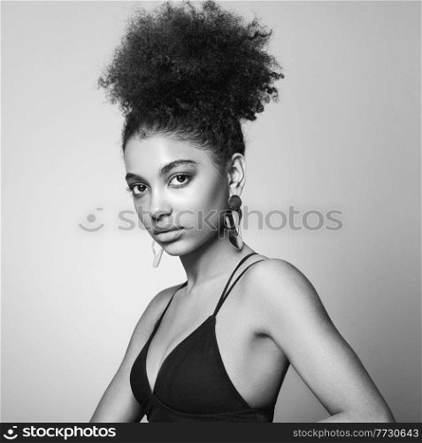 Beautiful smiling girl with curly hairstyle stock photo Women, African Ethnicity, Fashion Model, One Woman Only. Black and white photo