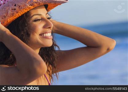 Beautiful smiling happy young mixed race sexy Hispanic woman in bikini and cowboy hat on a tropical beach