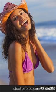 Beautiful smiling laughing happy young mixed race sexy Hispanic woman in bikini and cowboy hat on a tropical beach