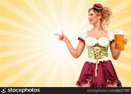 Beautiful smiling sexy Oktoberfest waitress wearing a traditional Bavarian dress dirndl holding beer mug, and pointing aside on colorful abstract cartoon style background.