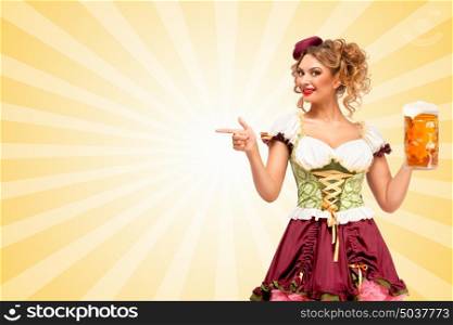 Beautiful smiling sexy Oktoberfest waitress wearing a traditional Bavarian dress dirndl holding beer mug, and pointing aside on colorful abstract cartoon style background.