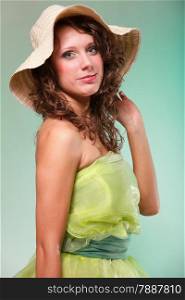 Beautiful smiling spring or summer woman in hat. Green concept