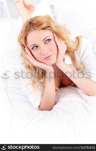 Beautiful smiling woman laying on bed
