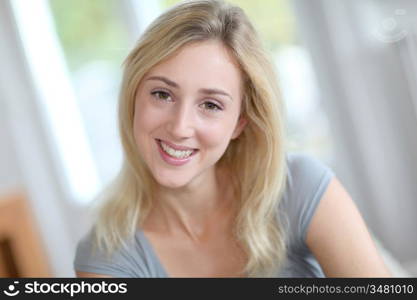 Beautiful smiling woman relaxing in sofa