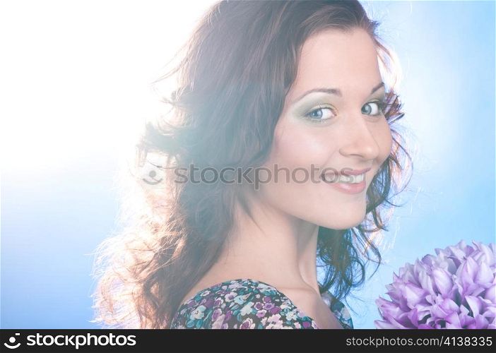 beautiful smiling woman with flower on blue background