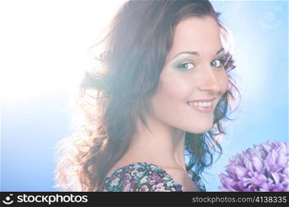 beautiful smiling woman with flower on blue background