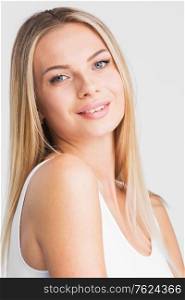 Beautiful smiling woman with long straight hair on a white background beauty skincare concept. Beautiful smiling woman with long hair
