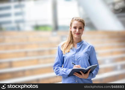 Beautiful smiling women look at camera while standing outdoor