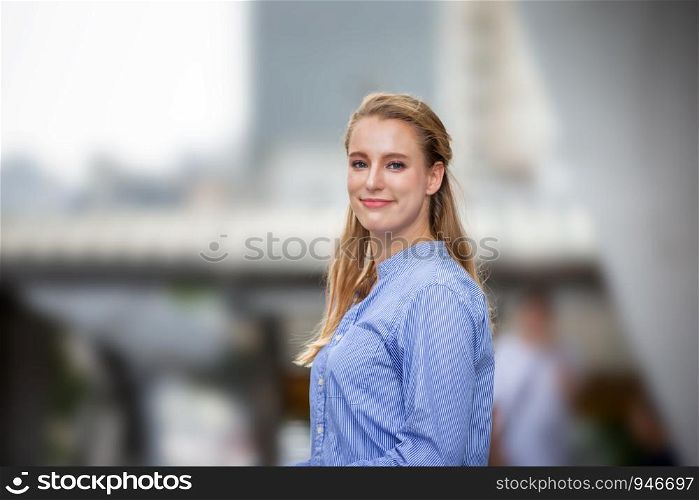 Beautiful smiling women look at camera while standing outdoor