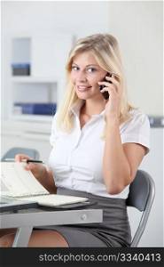 Beautiful smiling young woman working in the office