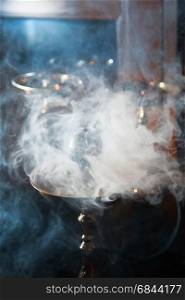 Beautiful smoke in the bowl of a hookah. close-up