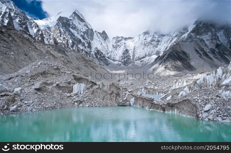 Beautiful snow-capped mountains with lake against the blue sky. Himalaya, Nepal. Beautiful snow-capped mountains with lake