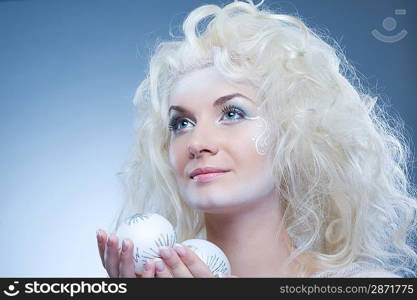 Beautiful snow queen with a christmas ball