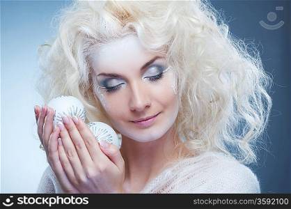 Beautiful snow queen with a christmas ball
