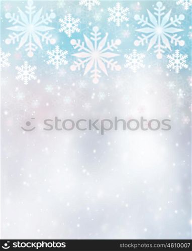 Beautiful snowflakes border on blurry background, cute Christmas greeting card with copy space, festive winter time decoration