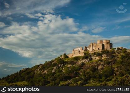 Beautiful Spanish old castle over a hill with a amazing sky of background