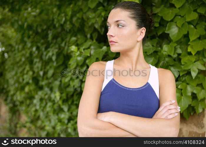 Beautiful sport woman portrait over outdoor green leaves background