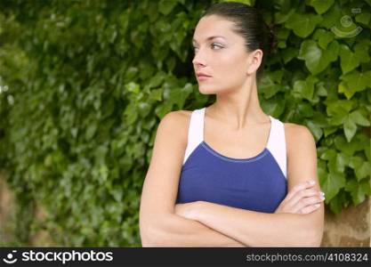 Beautiful sport woman portrait over outdoor green leaves background