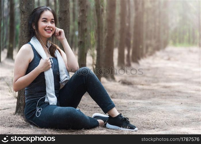 Beautiful sport young woman girl lifestyle exercise healthy drinking water from bottle after running workout in forest nature park with copy space
