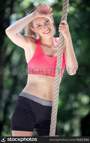 beautiful sports girl doing exercises with rope