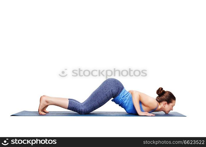 Beautiful sporty fit woman practices yoga asana Ashtangasana - eight-limbed pose variation in studio isolated on white. Sporty fit woman practices yoga asana Ashtangasana