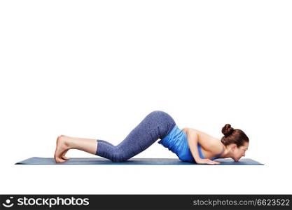 Beautiful sporty fit woman practices yoga asana Ashtangasana - eight-limbed pose variation in studio isolated on white. Sporty fit woman practices yoga asana Ashtangasana