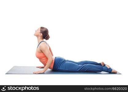 Beautiful sporty fit yogini woman practices yoga asana bhujangasana - cobra pose in studio isolated on white. Sporty fit yogini woman practices yoga asana bhujangasana