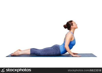 Beautiful sporty fit yogini woman practices yoga asana bhujangasana - cobra pose in studio isolated on white. Sporty fit yogini woman practices yoga asana bhujangasana 
