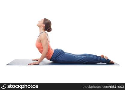 Beautiful sporty fit yogini woman practices yoga asana bhujangasana - cobra pose isolated on white background. Sporty fit yogini woman practices yoga asana bhujangasana 