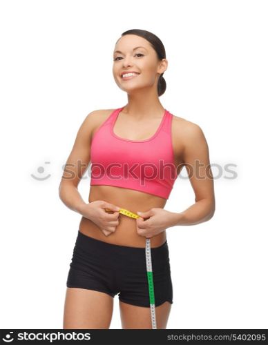 beautiful sporty woman with measuring tape