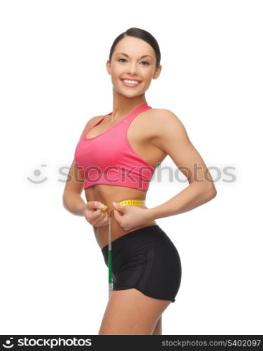 beautiful sporty woman with measuring tape
