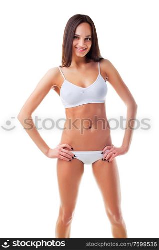 Beautiful sporty young woman is smiling on white background