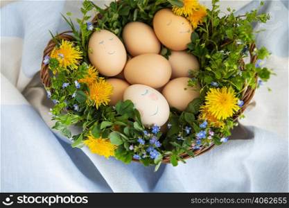 Beautiful spring bouquet in a wooden basket with Easter painted eggs, eggs with cute faces. Beautiful spring bouquet in a wooden basket with Easter painted eggs, eggs with cute faces.