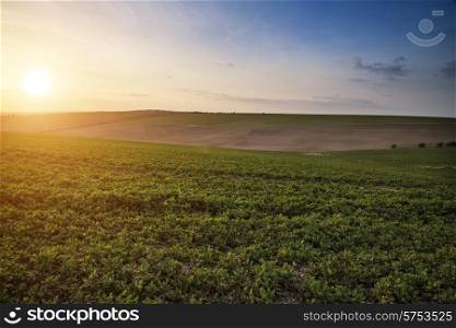 Beautiful Spring evening light over fields landscape on farm