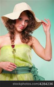 Beautiful spring or summer gently woman in hat with dry rose. Green concept