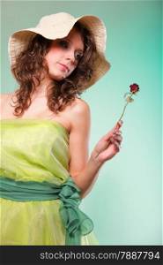 Beautiful spring or summer gently woman in hat with dry rose. Green concept