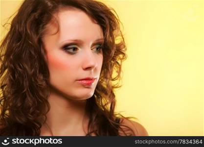 Beautiful spring or summer woman curly hair yellow background