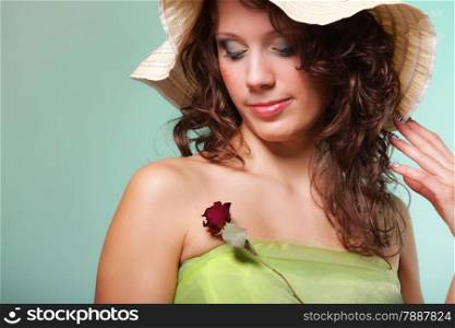 Beautiful spring or summer woman in hat with dry rose. Green concept