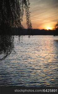 Beautiful Spring sunrise over calm lake in English countryside