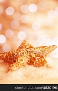 Beautiful star decoration, festive shiny golden bauble on blurry background, traditional Christmas time ornament, New Year eve concept