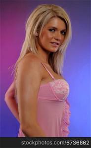 Beautiful statuesque blonde in a pink babydoll