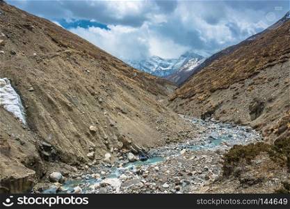 Beautiful stone river in the Himalayas on a spring Sunny day, Nepal.Beautiful stone river in the Himalayas on a spring Sunny day, Nepal.