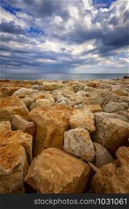 Beautiful stone shore seascape with colorful stones. Vertical view