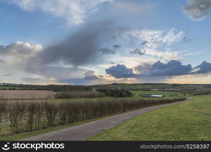 Beautiful stormy dramatic cloud formations over English countryside landscape