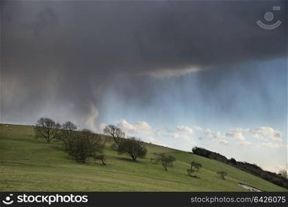 Beautiful stormy dramatic cloud formations over English countryside landscape