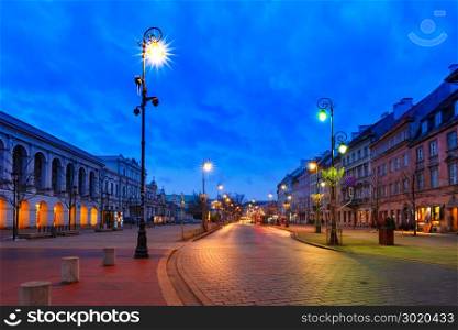 Beautiful street in Old Town of Warsaw, Poland. Krakowskie Przedmiescie street, part of the Royal Route in Old Town during evening blue hour, Warsaw, Poland.