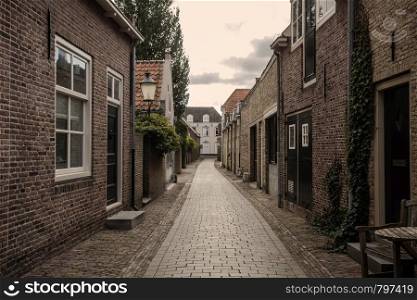 Beautiful street with traditional dutch architecture in the Netherlands cozy historic buildings. Beautiful street with traditional dutch architecture in the Netherlands