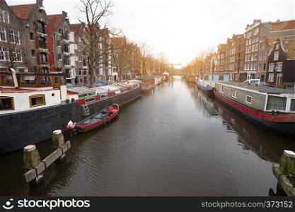 beautiful streets, canal and house on the water in the famous city of amsterdam, netherlands