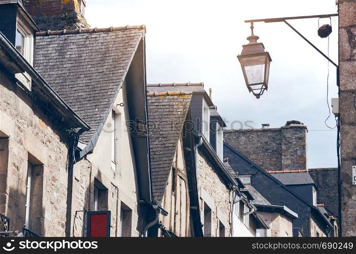 beautiful streets of the old famous city of Dinan in Normandy, France. street lamp in the foreground.